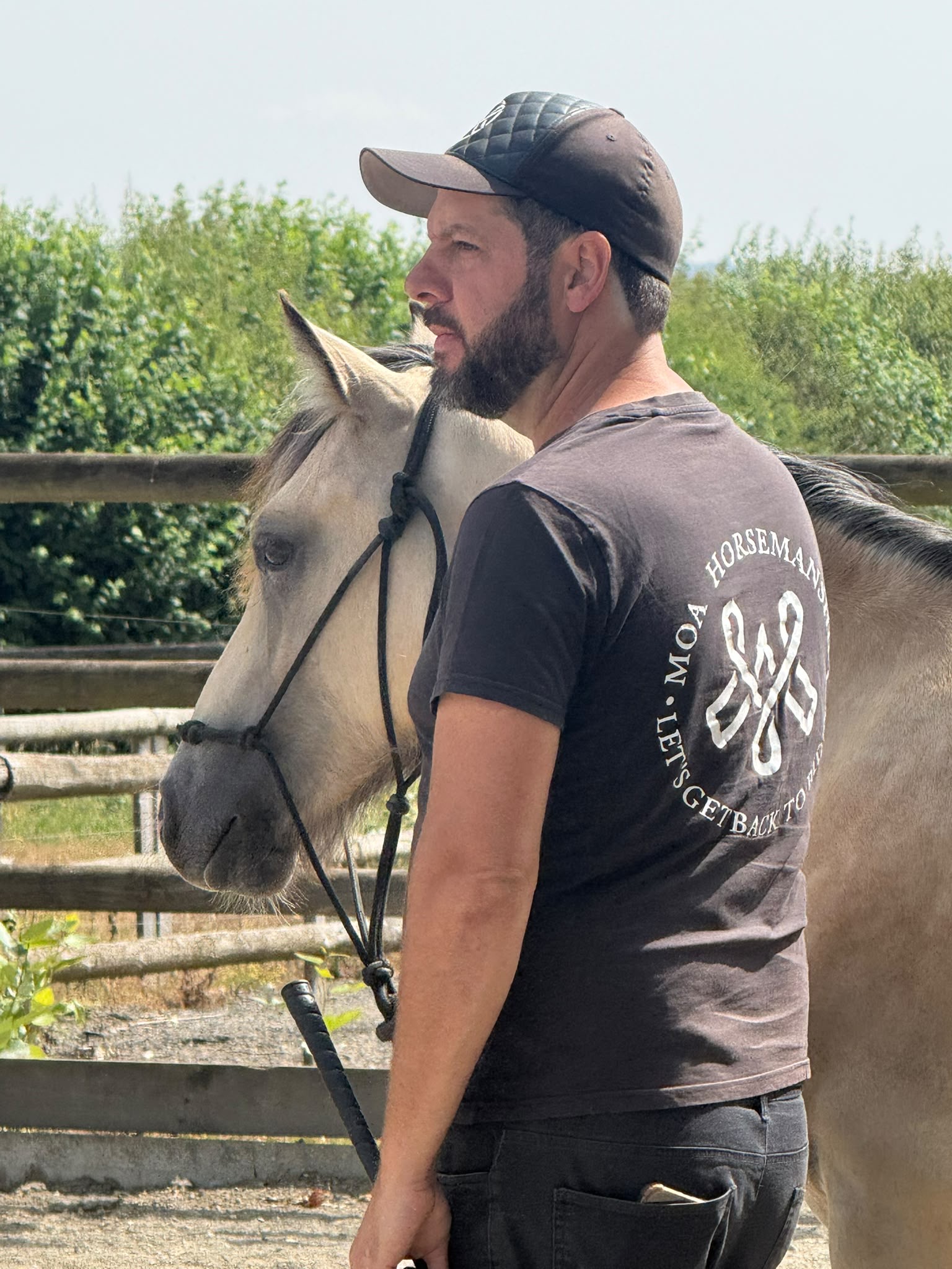 Moa working quietly beside a buckskin horse